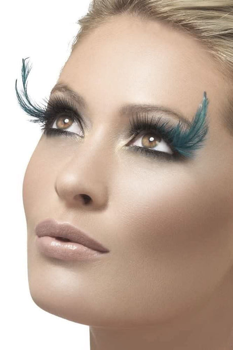 Close-up of woman wearing teal feather eyelashes for a bold fancy dress look