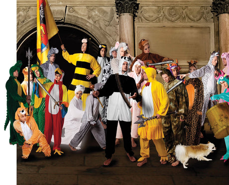 Group of people dressed in various animal and character costumes including a teen cow costume from Kids Fancy Dress