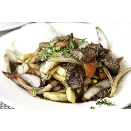 Stir-fried beef with onions and vegetables cooked in Tefal chefs delight wok served on a white plate