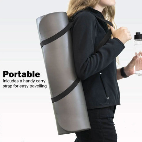 Person carrying a rolled gray non slip yoga mat for home workouts with a black adjustable strap