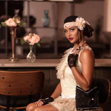 Woman wearing Charleston accessories set with pearl necklace, lace gloves, and headband with flower