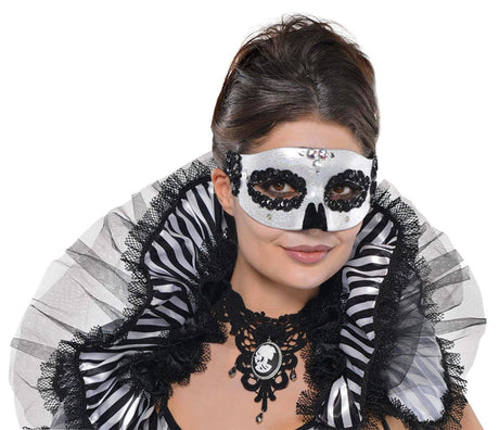 Elegant white Venetian skull mask for adults with black lace and sequin details worn by a woman