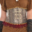 Close-up of metallic corset with bone details and red feather trim for witch doctor costume women