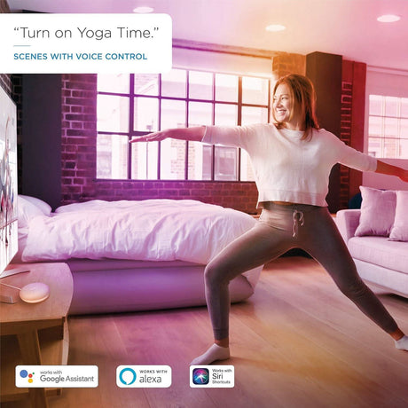 Woman doing yoga in a bright room illuminated by WiZ GU10 smart bulb with voice control compatibility
