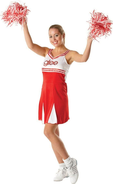 Woman wearing red and white women's cheerleader costume holding red pom poms and smiling