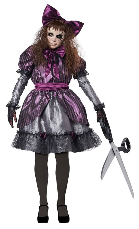 Women's horror doll costume with purple and black dress, large bow, creepy doll makeup, and oversized scissors