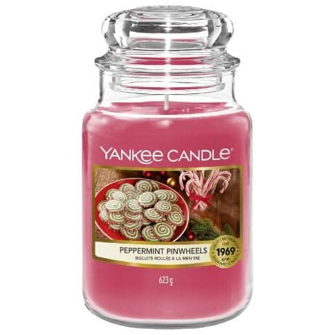 Yankee Candle Peppermint scent in a pink jar featuring peppermint pinwheels on the label