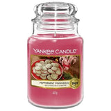 Yankee Candle Peppermint scent in a pink jar featuring peppermint pinwheels on the label