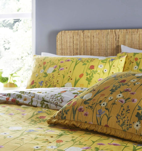 Yellow duvet cover super king size with floral pattern and matching pillowcases on wicker headboard bed